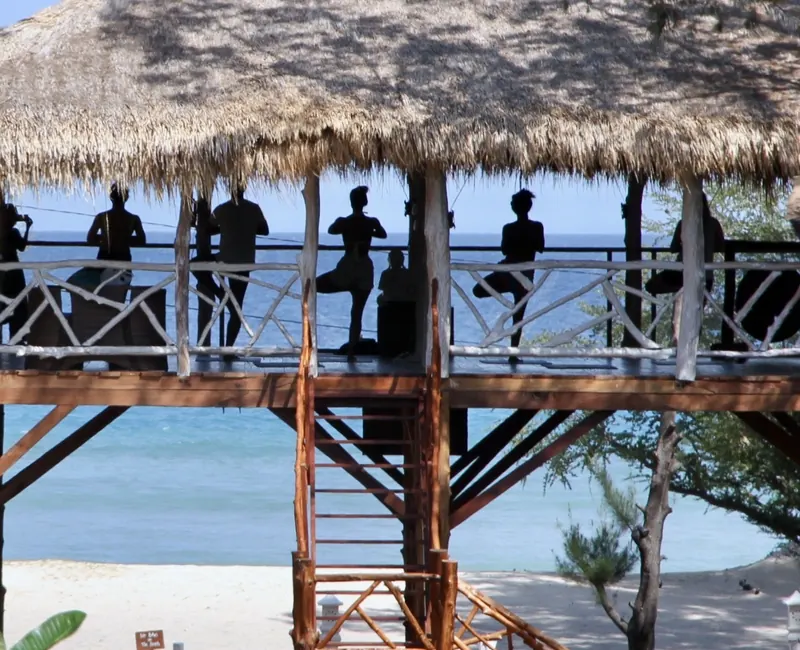 Silhouettes practicing yoga in the elevated pavilion